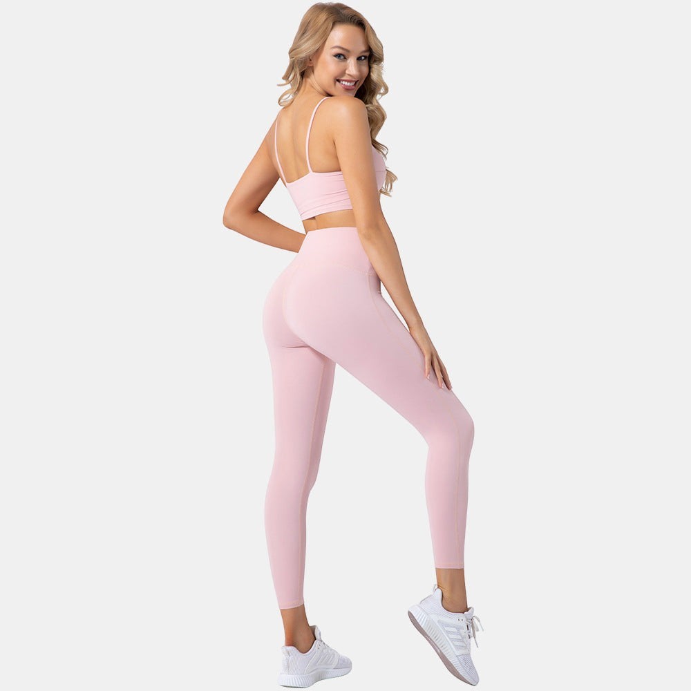 Blush and Bold women's light pink seamless yoga set with crop top and high-waist leggings. Breathable, flexible fabric.